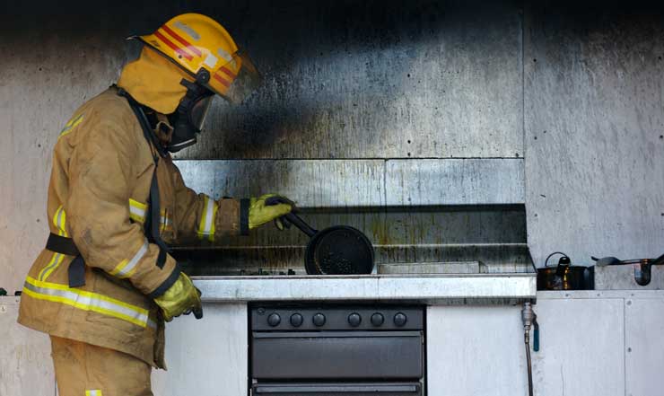 fire investigator looking at charred stove