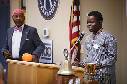 Abdul Kizito, a recent Ann Arbor Huron graduate, expresses his gratitude for a WCC scholarship from the Kiwanis Club of Ann Arbor at a luncheon on Monday, Oct. 21, as Kiwanis Past President William Hampton looks on.