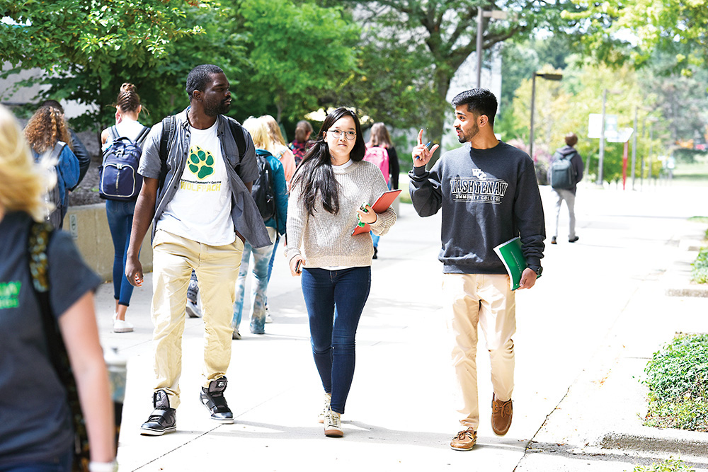 Students (from left) Paul Katokwe, Undraa Bayasgalan and Shahzar Mirza walk across a busy WCC campus during the first week of the Fall 2017 semester. | Photo by Lon Horwedel