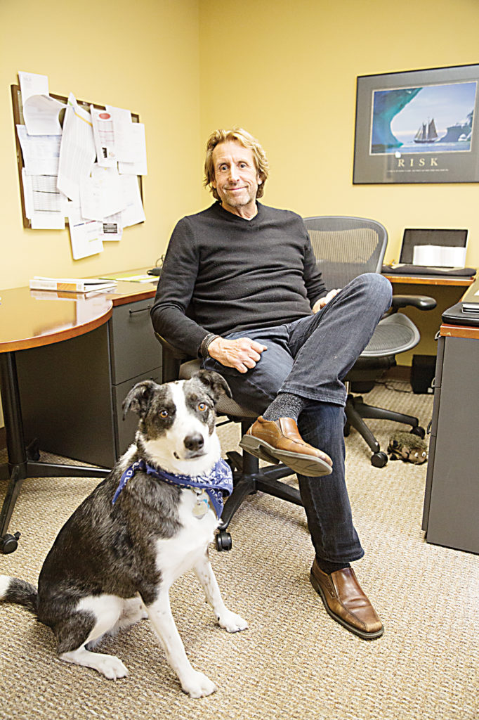 WCC alumni Jack Wilson and his dog, Max, in his Wiltec Technologies office. (Photo by Anne Savage)